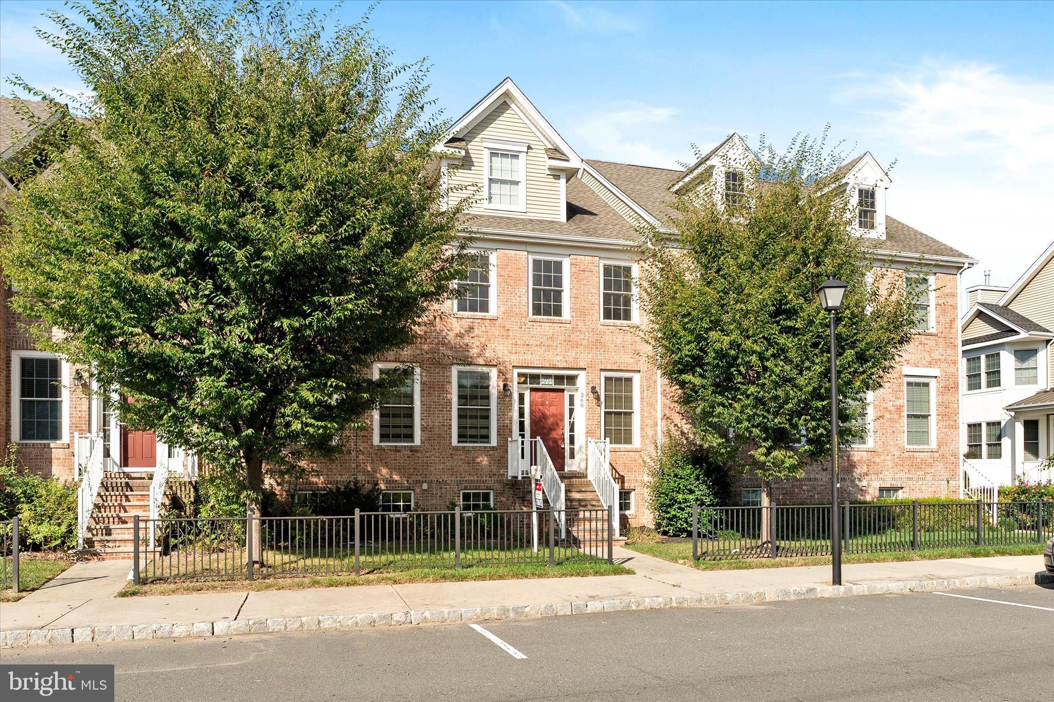 a view of a white house with a street