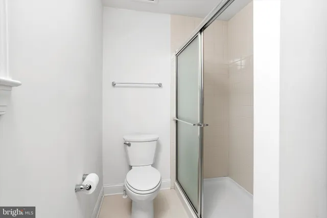 a bathroom with a toilet and a shower