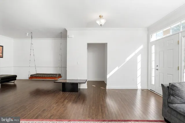a hallway with wooden floor and furniture