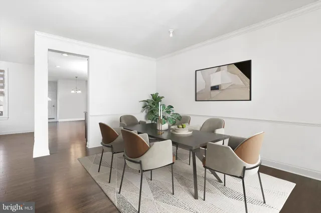 a dining room with furniture and wooden floor