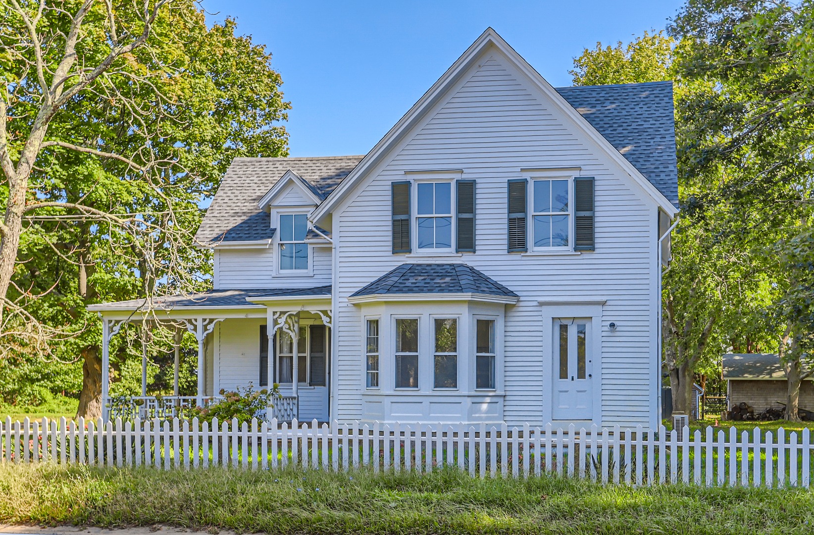 a front view of a house with a garden