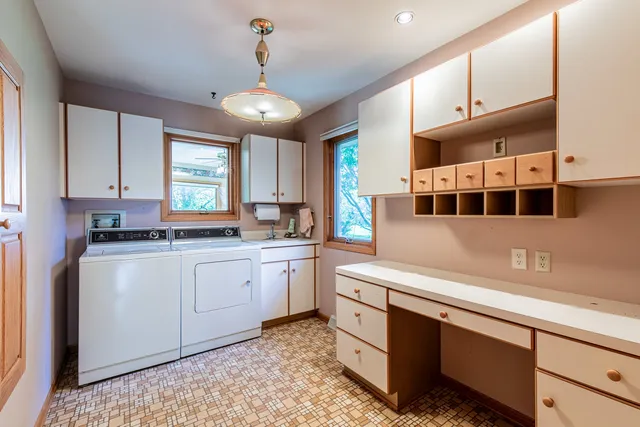 a kitchen with stainless steel appliances a refrigerator sink and cabinets