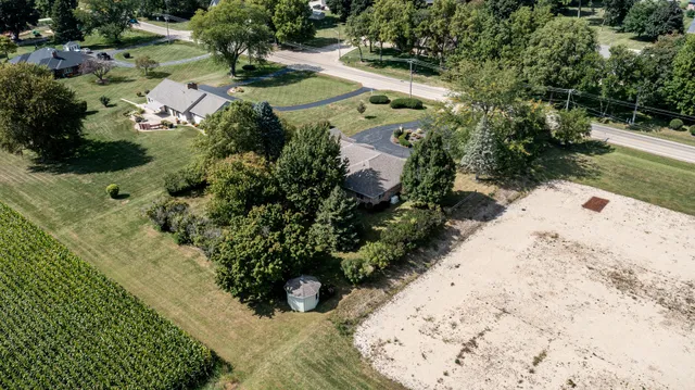 an aerial view of a house with a yard