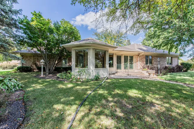 a view of a house with a yard porch and sitting area