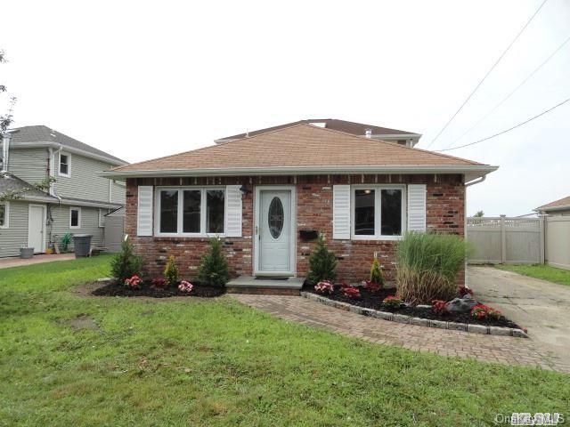 38 Waterford Road Island Park, NY 11558 - Photo 1 of 1 a front view of a house with a garden