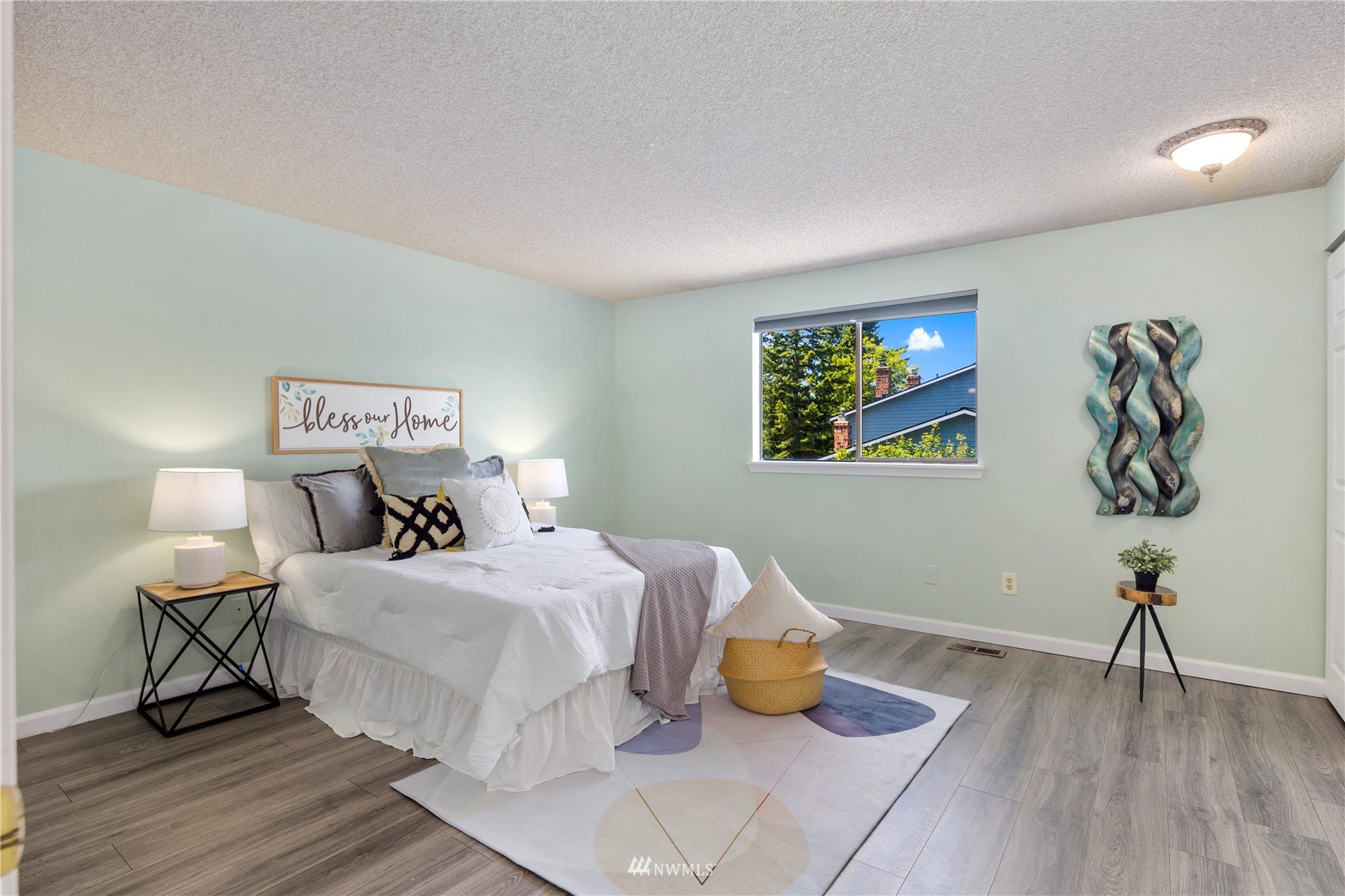 21527 4th Avenue West, Unit C44 Bothell, WA 98021 - Photo 16 of 40 a bedroom with a bed and wooden floor