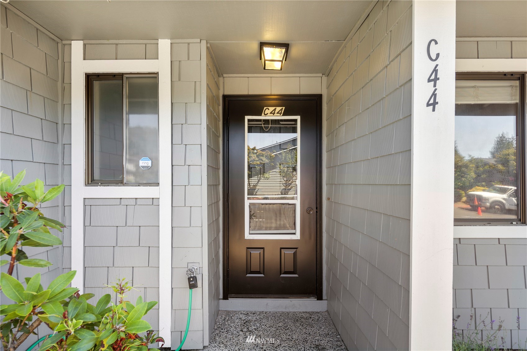 21527 4th Avenue West, Unit C44 Bothell, WA 98021 - Photo 27 of 40 a front view of a house with a blue gate