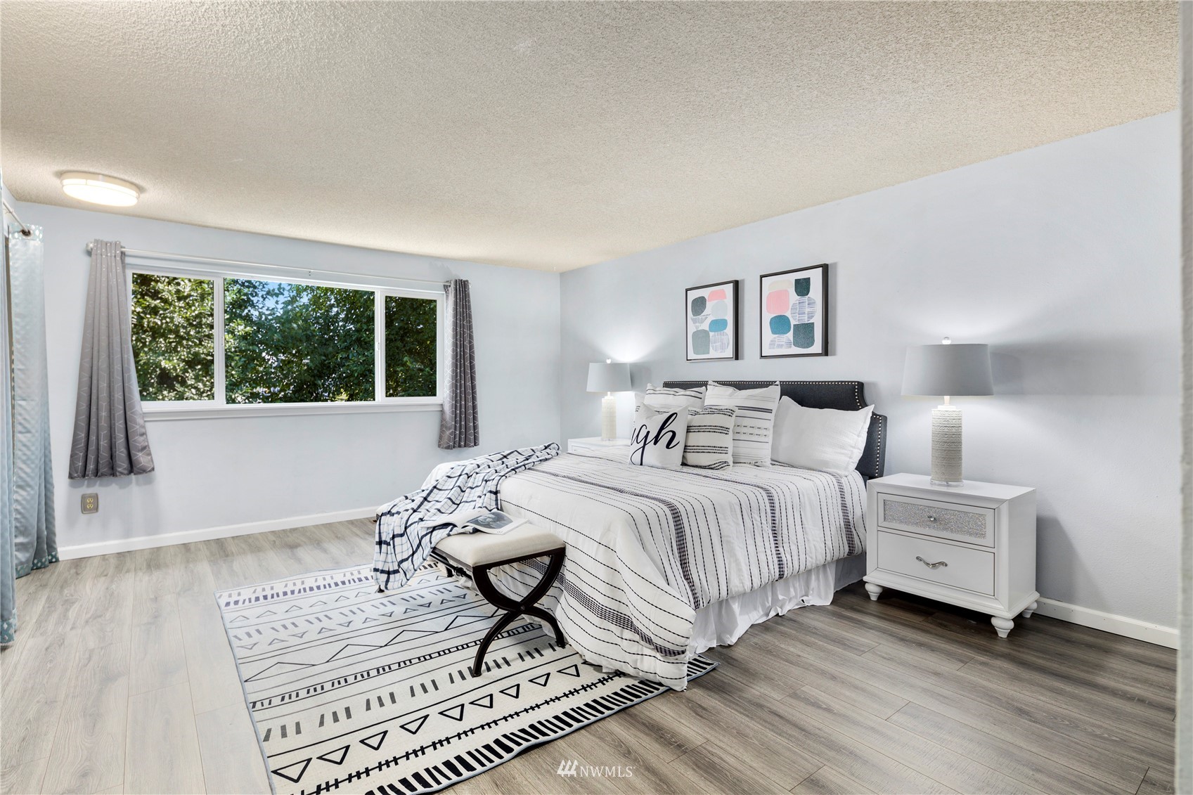 21527 4th Avenue West, Unit C44 Bothell, WA 98021 - Photo 3 of 40 a bedroom with a bed and a large window