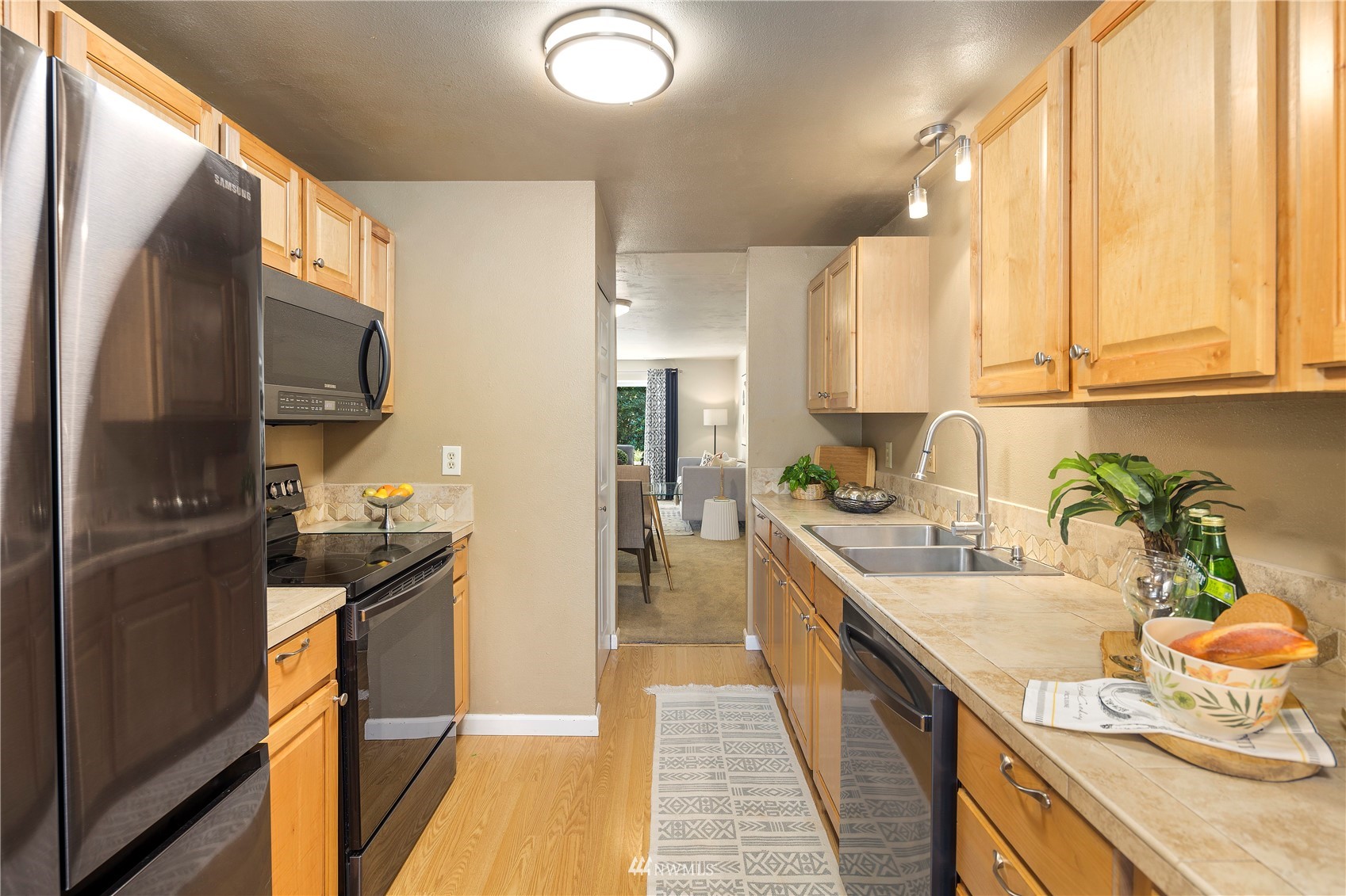 21527 4th Avenue West, Unit C44 Bothell, WA 98021 - Photo 5 of 40 a kitchen with a sink stove and refrigerator