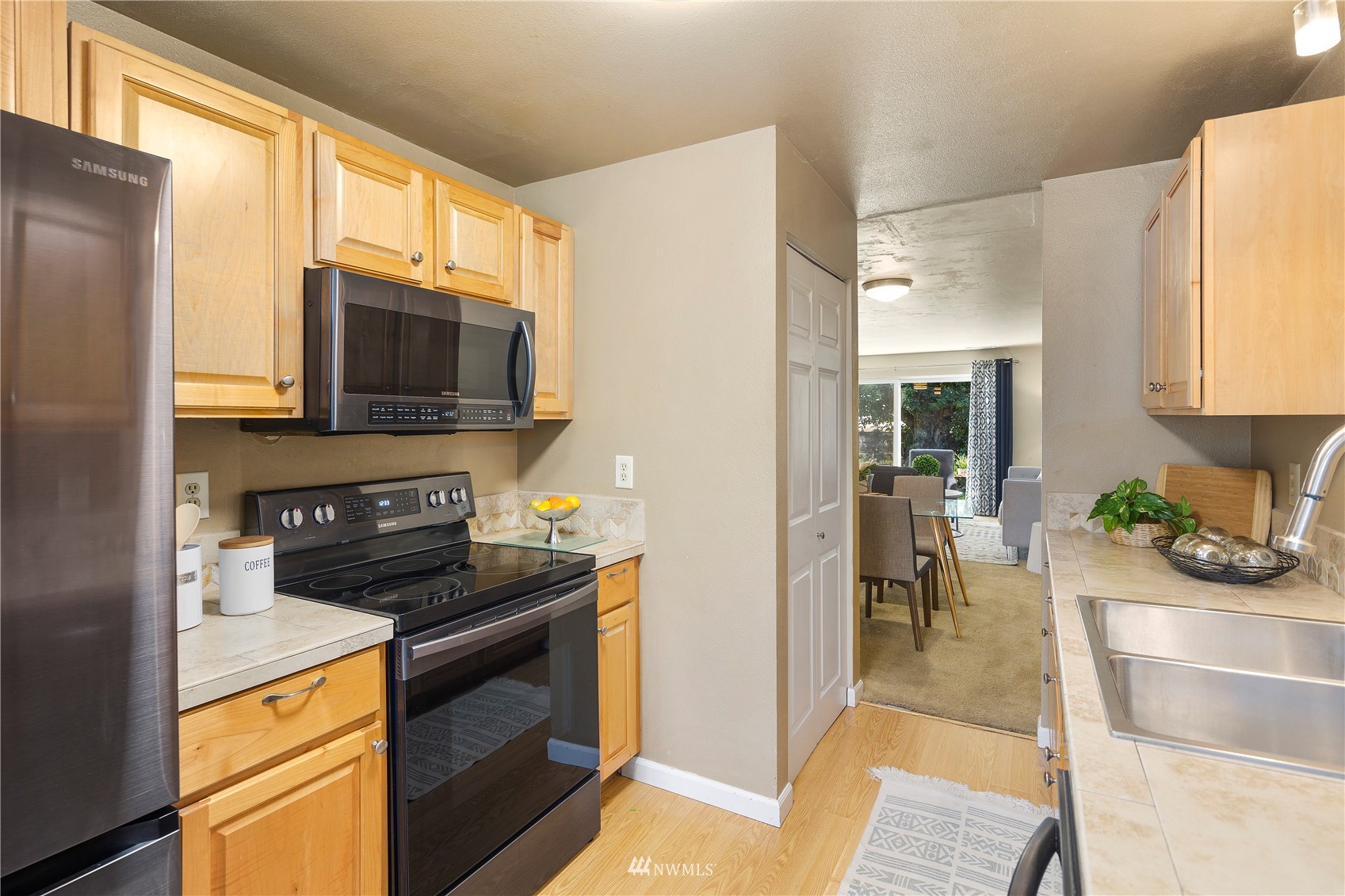 21527 4th Avenue West, Unit C44 Bothell, WA 98021 - Photo 6 of 40 a kitchen with stainless steel appliances a stove a sink and a microwave