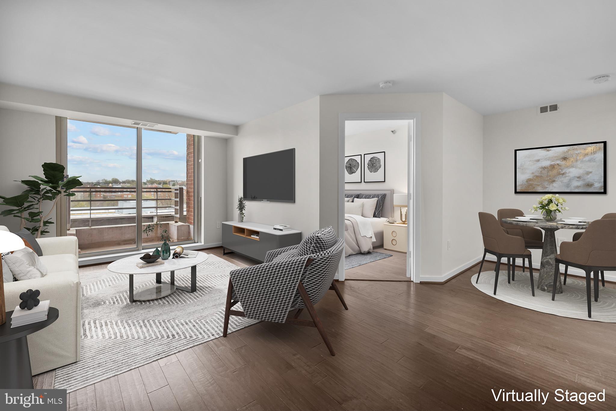 1275 25th Street Northwest, Unit 701 Washington, DC 20037 - Photo 11 of 36 a living room with furniture wooden floor and a flat screen tv
