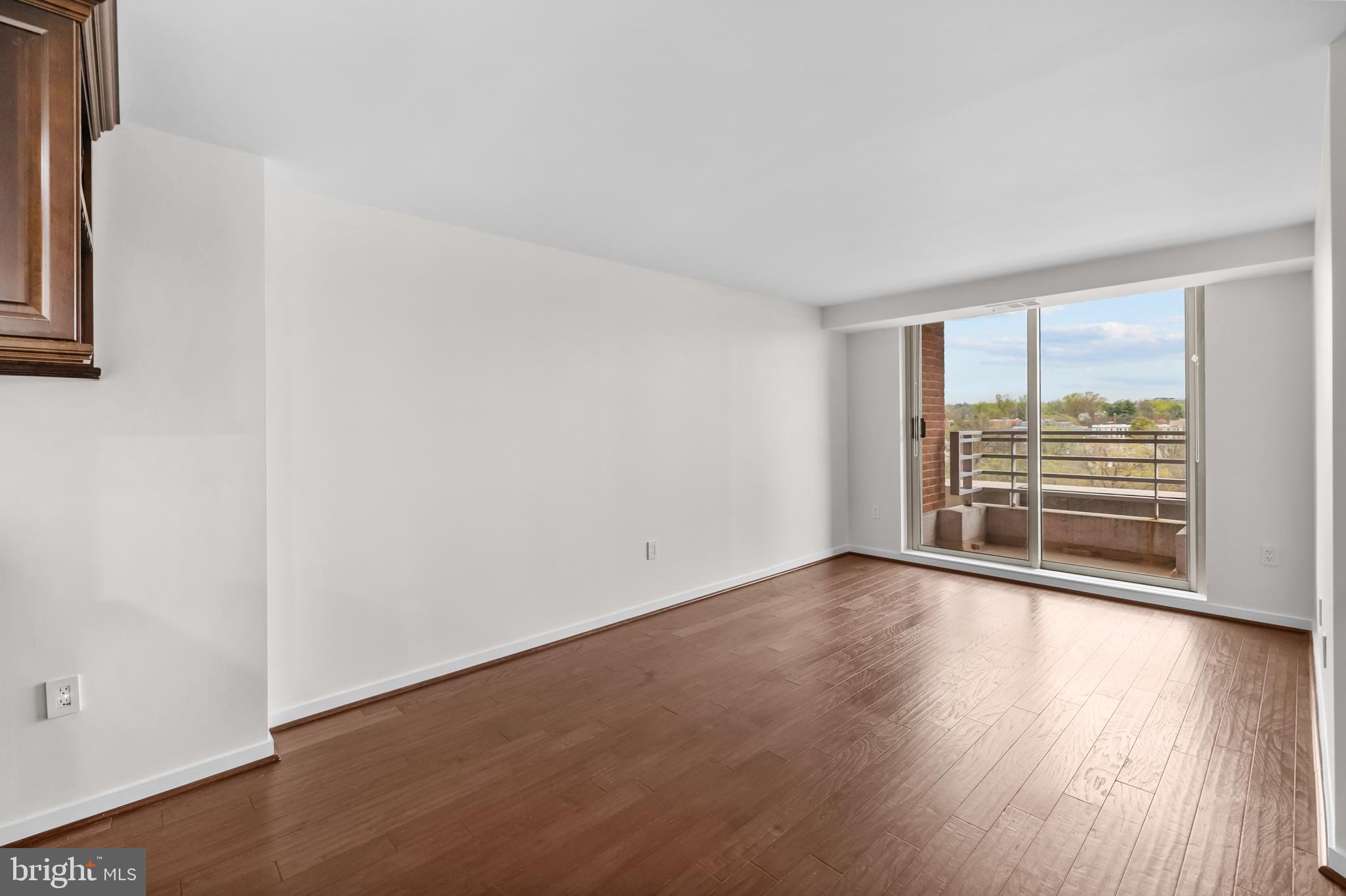 1275 25th Street Northwest, Unit 701 Washington, DC 20037 - Photo 13 of 36 an empty room with wooden floor and windows