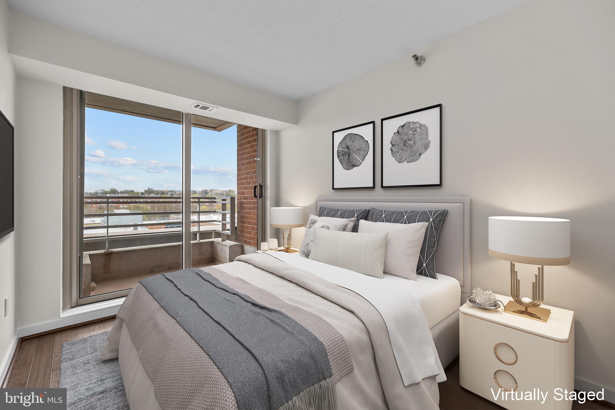 1275 25th Street Northwest, Unit 701 Washington, DC 20037 - Photo 15 of 36 a bedroom with a large bed and a lamp