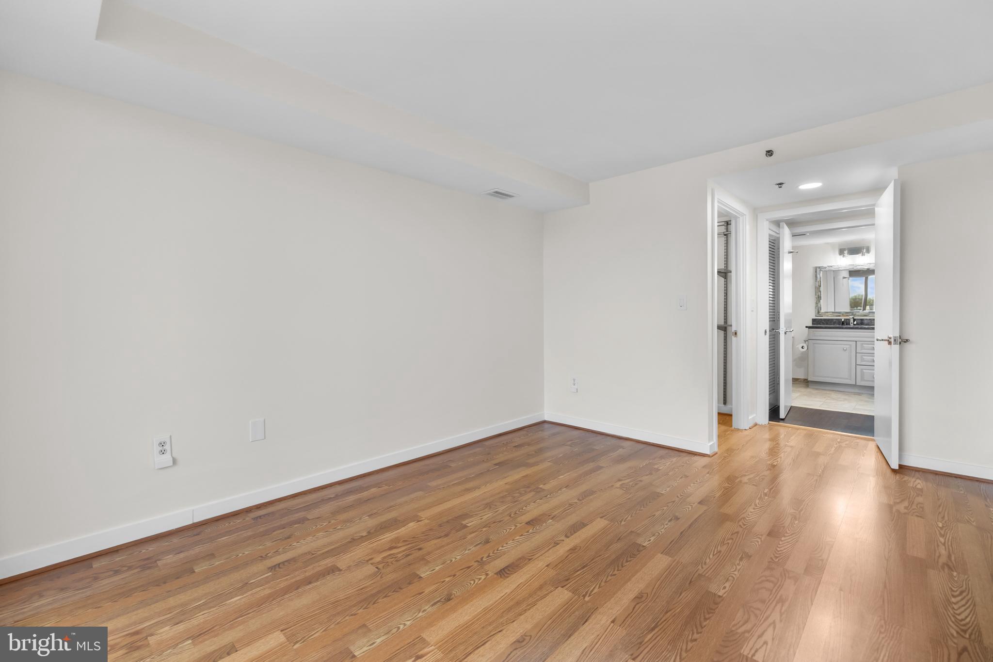 1275 25th Street Northwest, Unit 701 Washington, DC 20037 - Photo 17 of 36 a view of an empty room with wooden floor