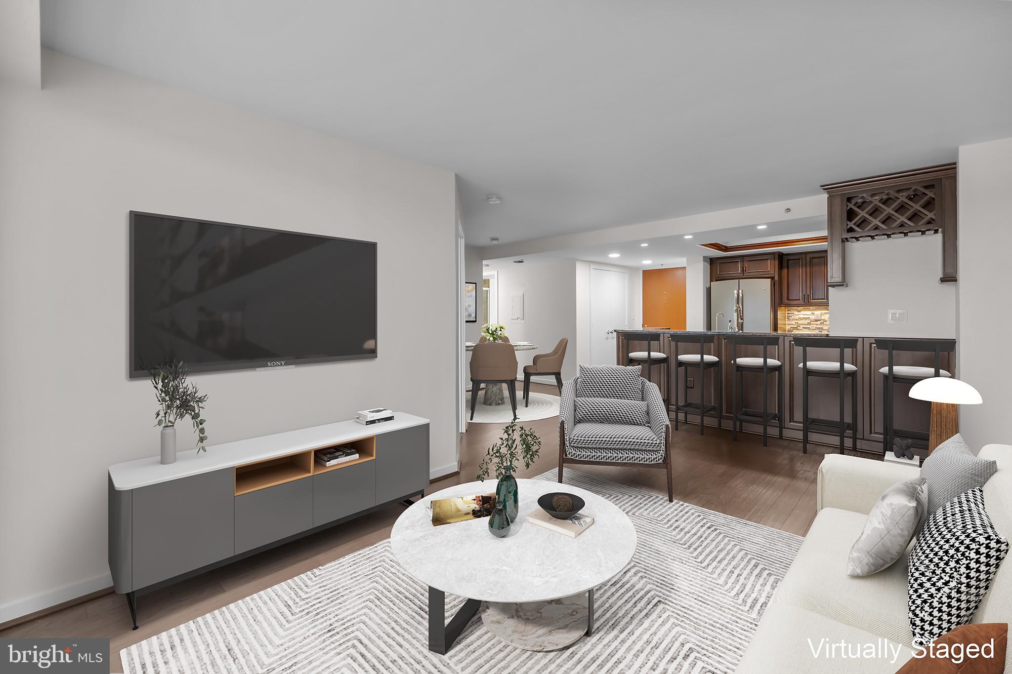 1275 25th Street Northwest, Unit 701 Washington, DC 20037 - Photo 9 of 36 a living room with furniture and a flat screen tv