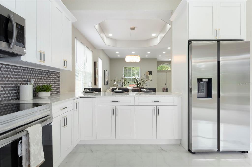 2306 Colusa Lane Valrico, FL 33596 - Photo 15 of 50 a large white kitchen with a white cabinets