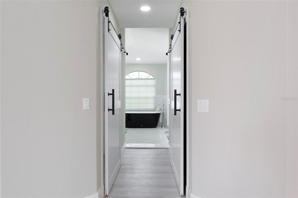 2306 Colusa Lane Valrico, FL 33596 - Photo 21 of 50 a bathroom with a glass shower door and a mirror