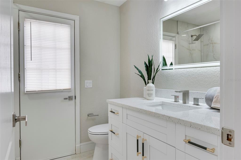 2306 Colusa Lane Valrico, FL 33596 - Photo 27 of 50 a bathroom with a sink a toilet and with mirror
