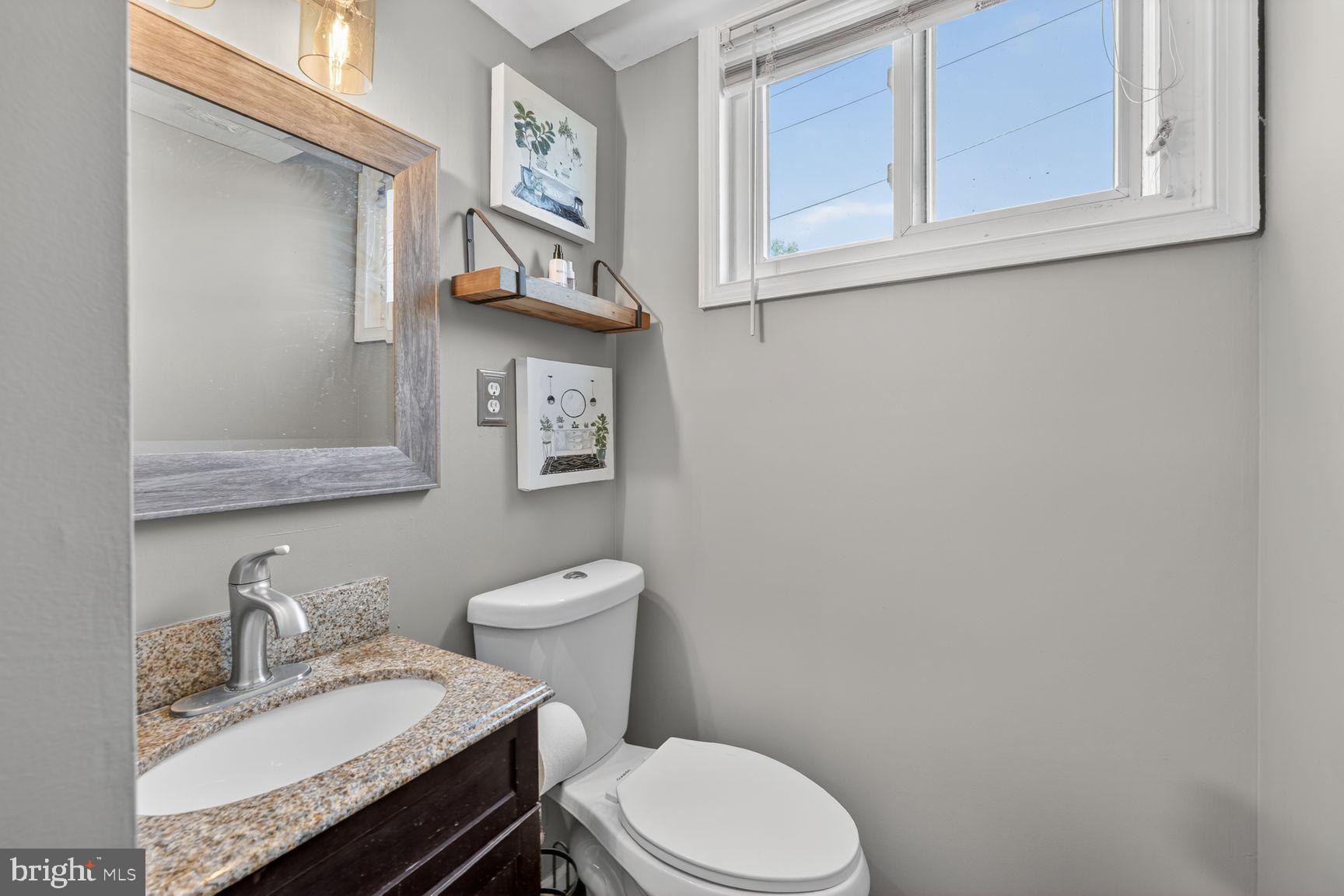 1104 Caddington Avenue Silver Spring, MD 20901 - Photo 20 of 35 a white toilet sitting next to a bathroom sink