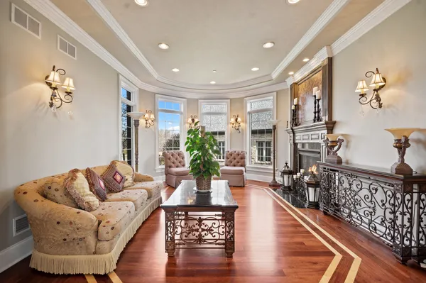 a living room with furniture a flat screen tv and a fireplace