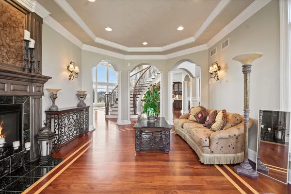 a living room with furniture a flat screen tv and a fireplace