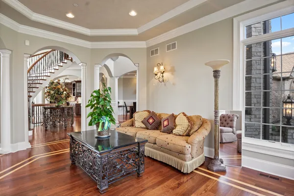 a kitchen with stainless steel appliances kitchen island granite countertop wooden floors and wooden cabinets
