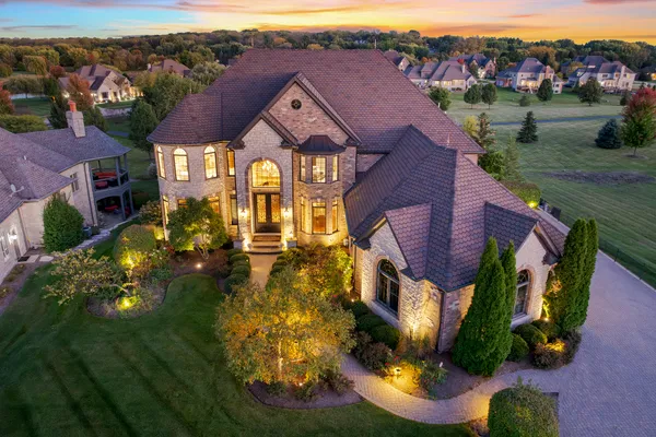 an aerial view of residential houses with outdoor space and parking