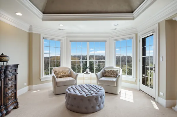 a living room with furniture a flat screen tv and large window