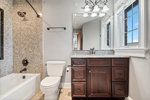 front view of a brick house with a chandelier