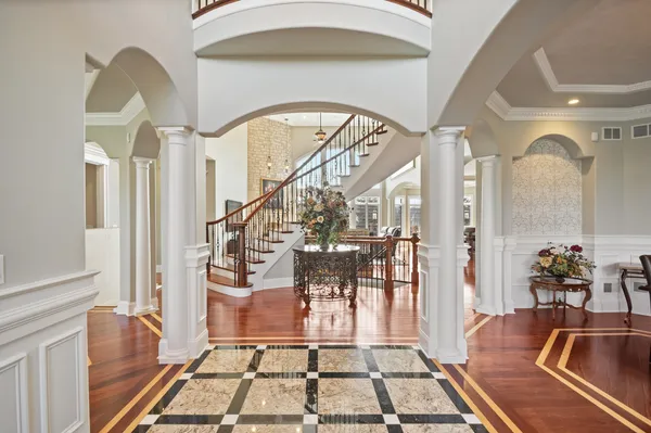 a view of a dining room with furniture a chandelier and wooden floor