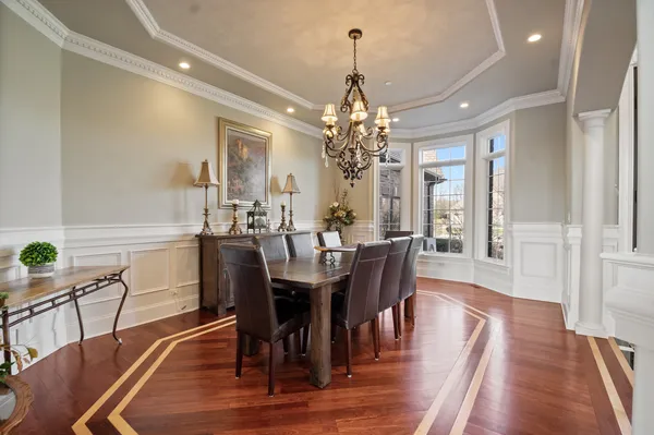 a living room with furniture a fireplace and a floor to ceiling window