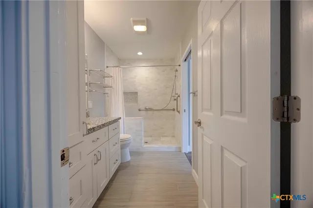 a bathroom with a glass shower door and a sink