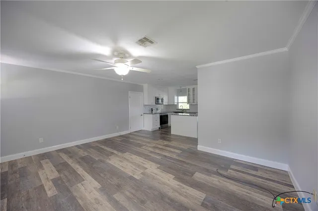 a view of a kitchen with a sink and a cabinet
