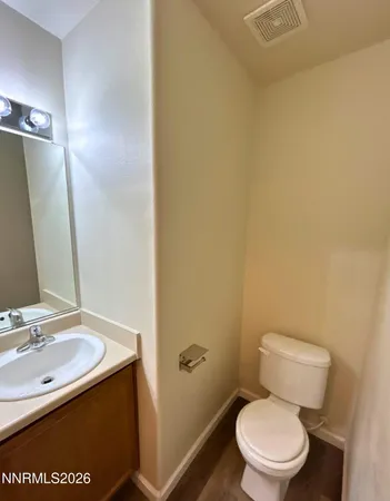 a white toilet sitting next to a bathroom sink