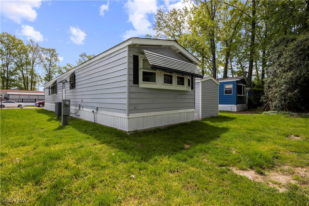 35157 Center Ridge Road, Unit 117 North Ridgeville, OH 44039 - Photo 20 of 21 View of side of home with a lawn