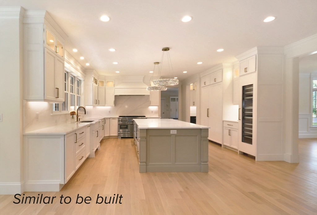 76 Martin Road Concord, MA 01742 - Photo 3 of 16 a large kitchen with a large counter top a sink stainless steel appliances and cabinets