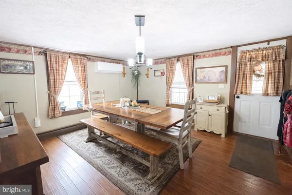 a living room with a couch a table and wooden floor