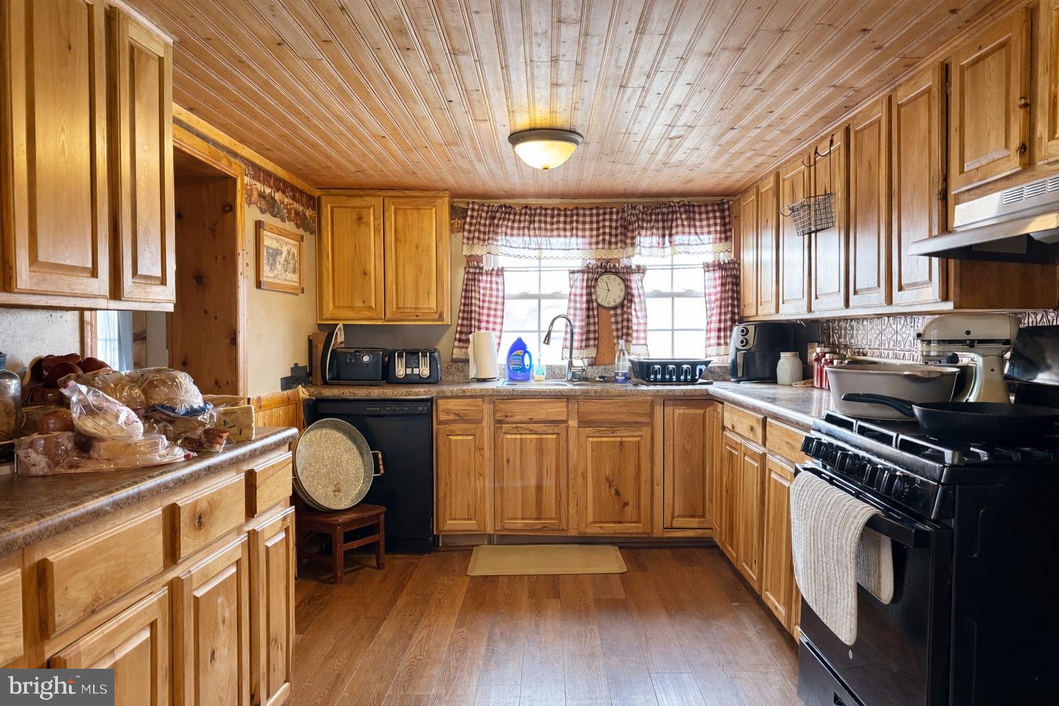 228 Rockey Road Loganton, PA 17747 - Photo 17 of 39 a kitchen with a sink appliances cabinets and a large window