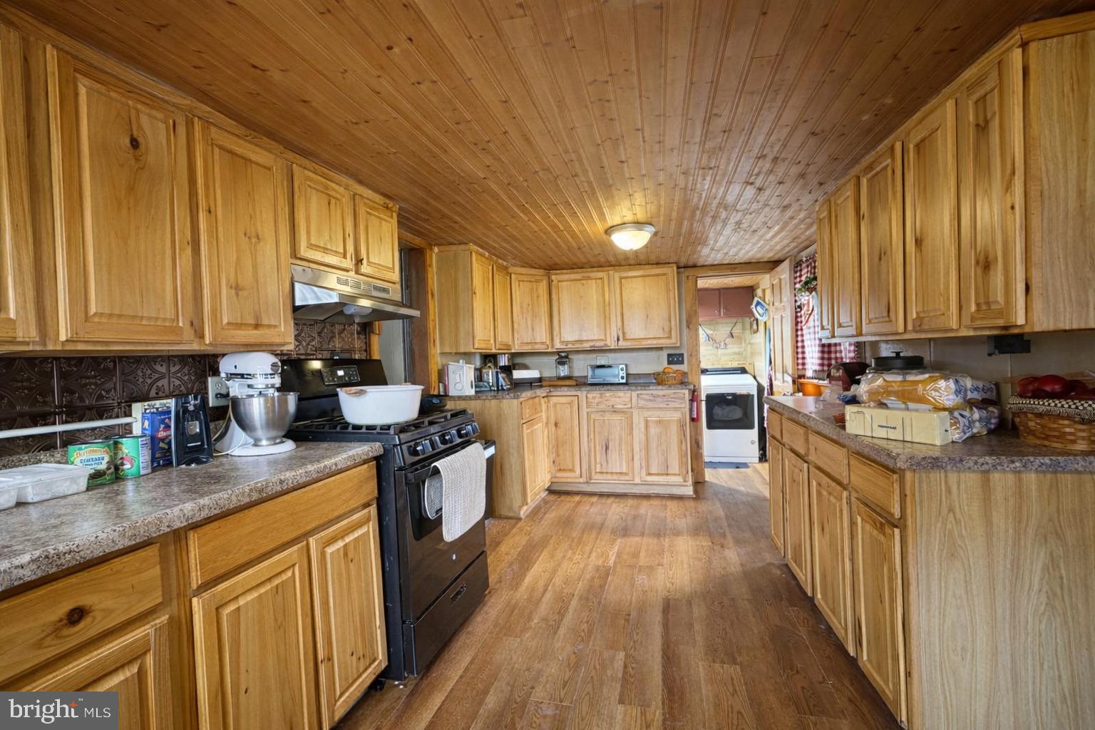 228 Rockey Road Loganton, PA 17747 - Photo 18 of 39 a kitchen with stainless steel appliances granite countertop a stove a sink dishwasher and a refrigerator