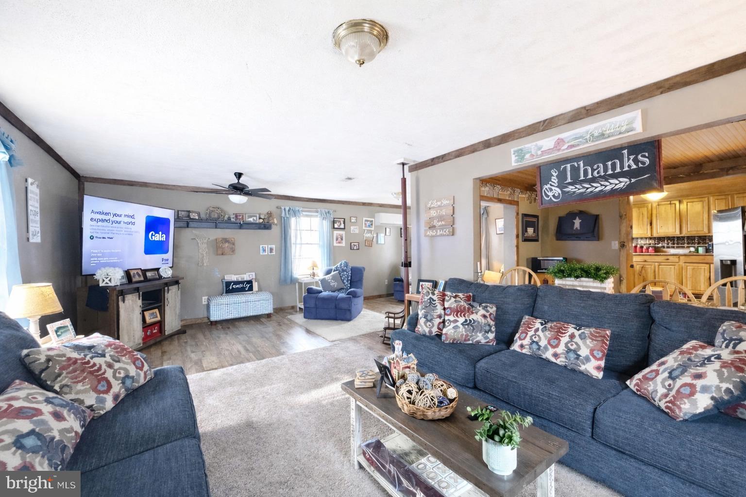 228 Rockey Road Loganton, PA 17747 - Photo 25 of 39 a living room with furniture and a flat screen tv