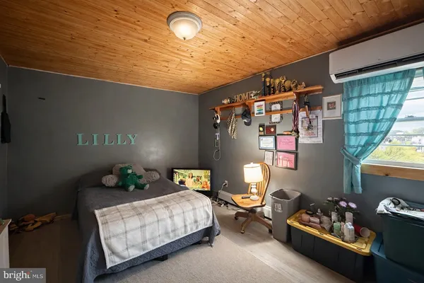 a bedroom with furniture and a window