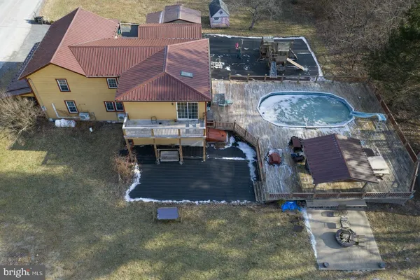 an aerial view of a house with a yard and lake view