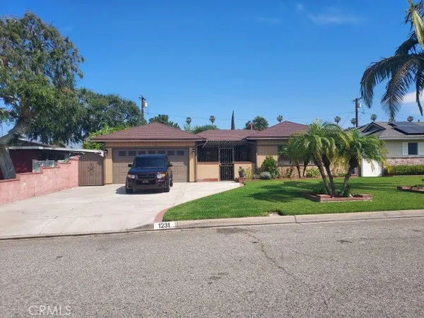 a front view of a house with a yard and a garage