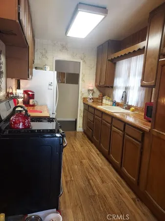 a room with a sink bed and cabinets