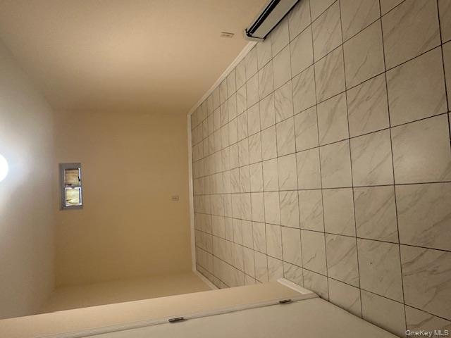 239-13 86th Avenue Queens, NY 11426 - Photo 12 of 12 Unfurnished room with a baseboard radiator and baseboards