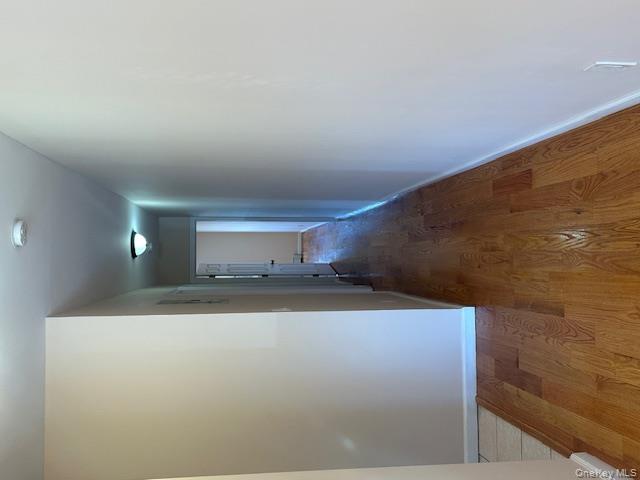 239-13 86th Avenue Queens, NY 11426 - Photo 8 of 12 Hall featuring light wood-type flooring and baseboards