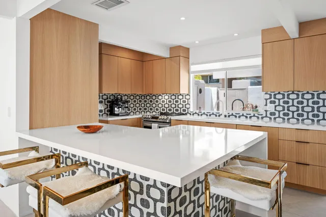 a kitchen with a sink a stove and a refrigerator