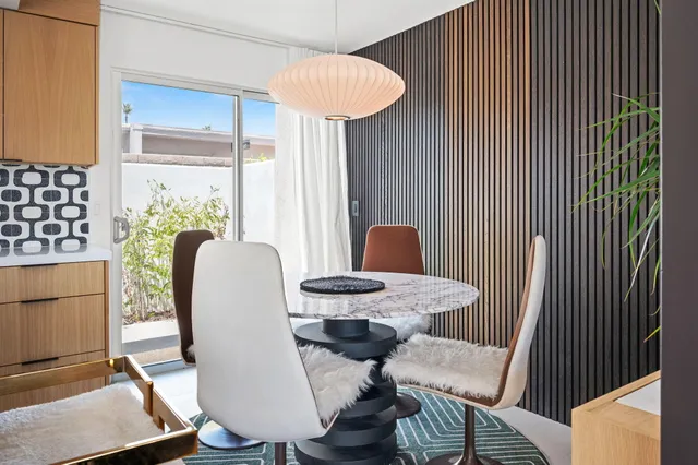 a dining room with furniture and wooden floor