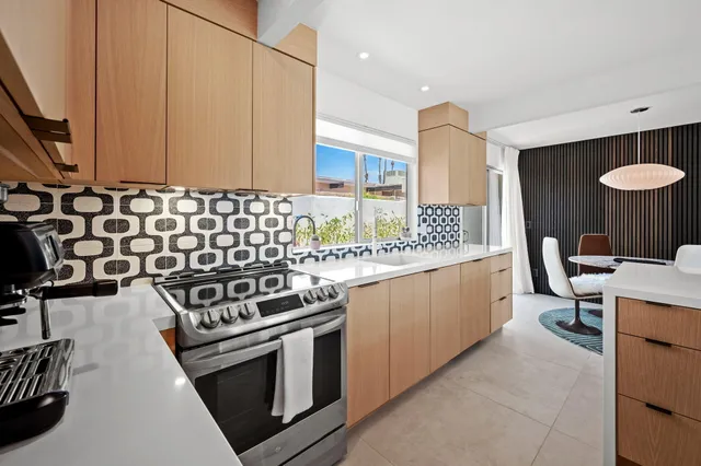 a kitchen with a sink stove and cabinets