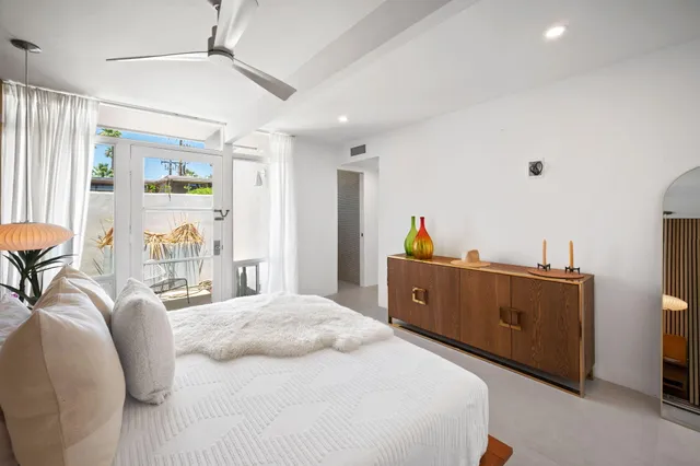 a view of a bedroom with furniture and a window